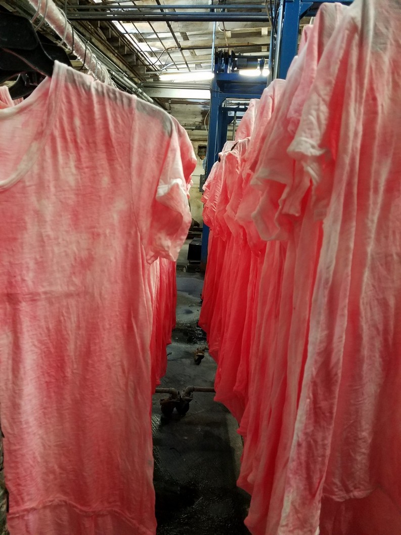 Photo of process finishing line with hanging clothing