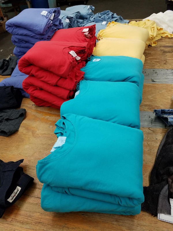 Photo of stacked and folded shirts showing available samples