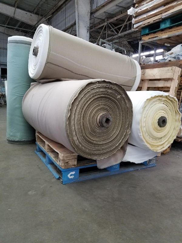 Photo of large fabric rolls with nearby pallets